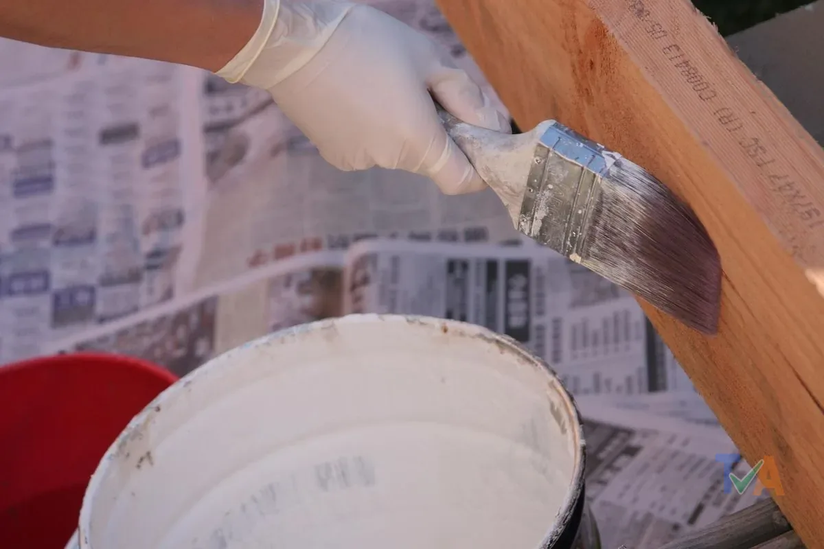 Person doing DIY home improvement painting a wall with brush