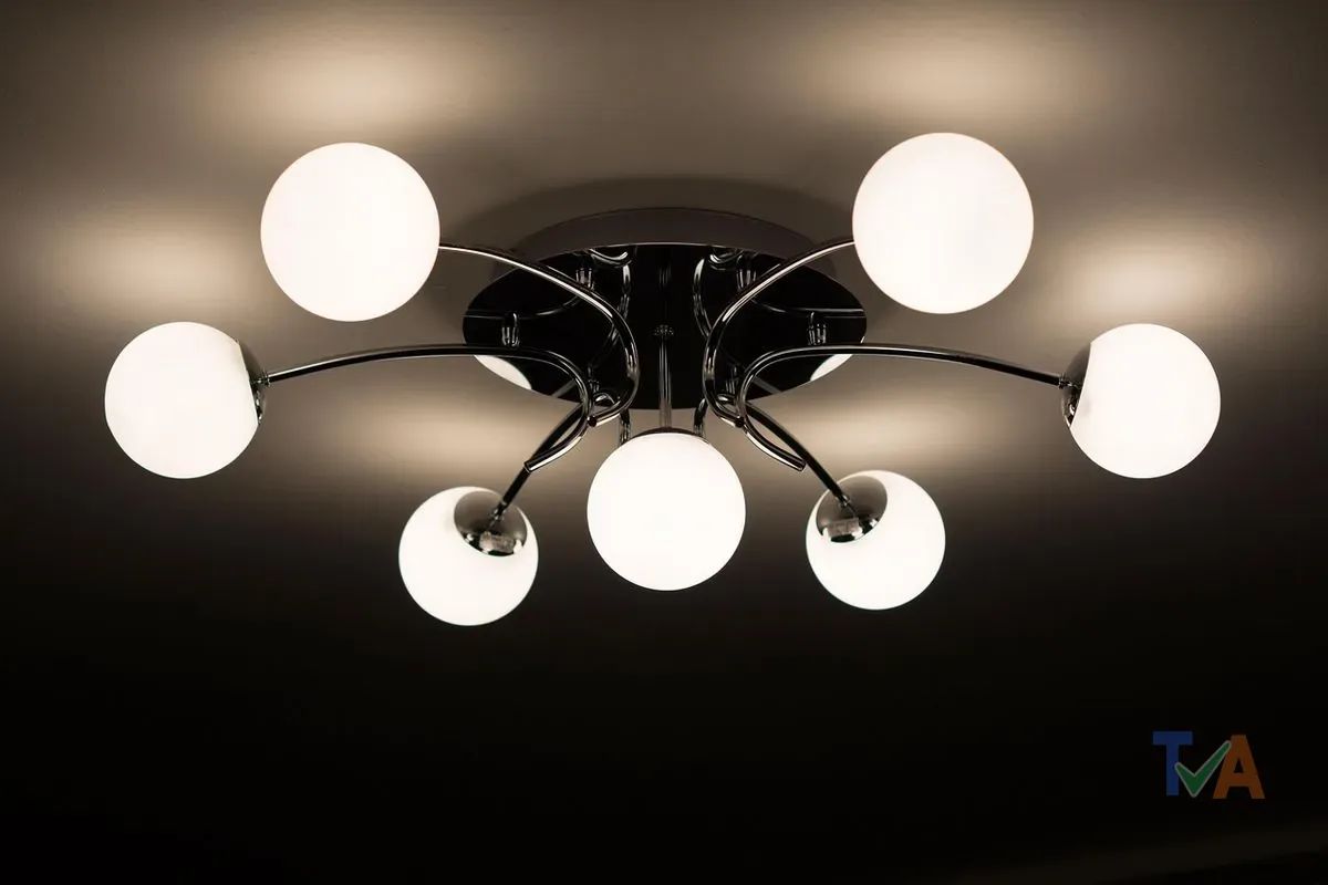Electrician installing ceiling light fixture wiring in residential home